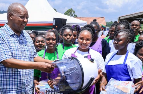 Nyamira Governor Amos Nyaribo (centre) presents a working toolkit to one of the best well performed VTC graduate at Mwongori VTC.