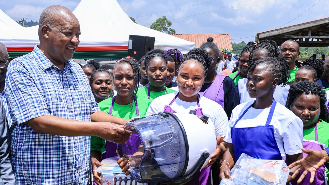 Nyamira Governor Amos Nyaribo (centre) presents a working toolkit to one of the best well performed VTC graduate at Mwongori VTC.